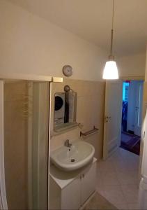 a bathroom with a sink and a shower and a mirror at Carachouse - Bologna in Bologna