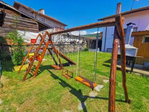 a playground with a swing set in a yard at Guest House Dorkos in Dorkovo