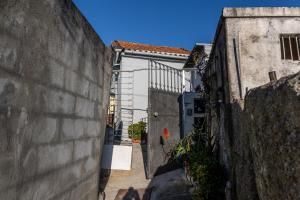 an alley with a white door and a building at House on a rustic Island At Campanha Trainstation in Porto