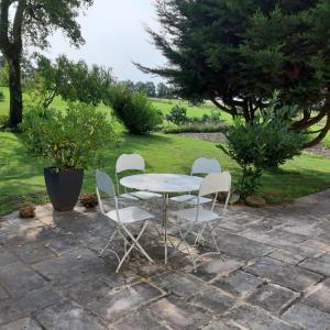 a table and four chairs sitting on a patio at Gite du SERAYOL in Morlhon-le-Haut