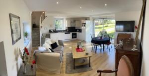 a living room with a couch and a table at Gite du SERAYOL in Morlhon-le-Haut