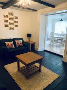 a living room with a couch and a coffee table at Little Bere apartment in Lifton