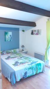 Schlafzimmer mit einem Bett mit blauer Wand in der Unterkunft Location d'un pavillon de vacances in Marseillan