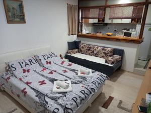 a living room with a bed and a couch at APARTMAN AZRA in Sarajevo