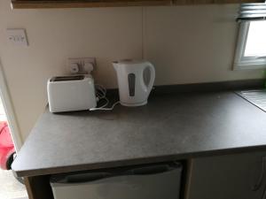a kitchen counter with a toaster sitting on a counter top at 709 Seawick in Jaywick Sands