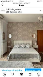 a bedroom with a white bed and a wall at Il Piccolo Attico in Caltagirone