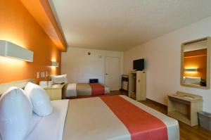 a hotel room with two beds and a television at Motel 6-Frederick, MD - Fort Detrick in Frederick