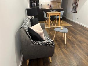 a living room with a couch and a table at Marina'home in Ajaccio