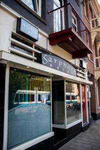 a store front with a reflection of a bus in the windows at Amsterdam Hostel Sarphati in Amsterdam