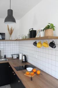 a kitchen with oranges on a wooden counter top at Studio apartman Siget II in Zagreb