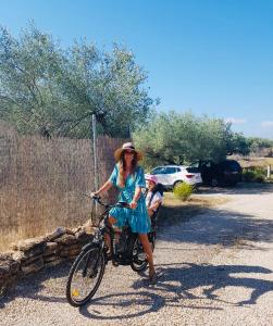 a woman and a child sitting on a bike at Bellissima Bell Tent - Romantic Glamping Retreat in Nature in Tortosa