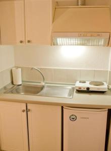 a kitchen with a sink and a stove at Ena-Lia Studios in Skala Marion +13 photos