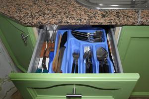 a drawer full of utensils sitting under a counter at Apartamento Auditorio in Alicante