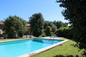 a swimming pool in the yard of a house at Casa de Romao in Amares
