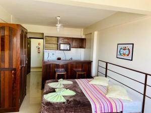 a bedroom with a bed with two pillows on it at Apart-Hotel Pacífico in Tramandaí