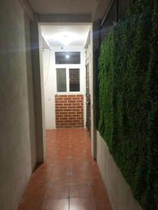 a hallway with a green wall in a building at HuehueLoft1 estacionamiento y wifi in Huehuetenango