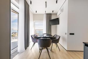 a dining room with a table and chairs and a window at Luxury Waterfront 3-bedrooms Apartment in Odesa