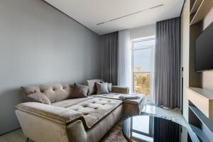 a living room with a couch and a glass table at Luxury Waterfront 3-bedrooms Apartment in Odesa