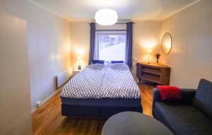 a bedroom with a bed and a window and a couch at Segla Guesthouse - Lovely sea view in Fjordgård