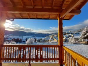 a view from the deck of a cabin in the snow at L'Etoile Du Berger in Les Angles