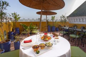 a white table with dishes of food on it at Riad Kech Soul Boutique & Spa in Marrakech