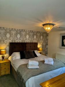 a bedroom with a large bed with two pillows on it at Jasmine House in Lutterworth