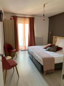 a bedroom with a large bed and a window at Slow Living B&B in Matera