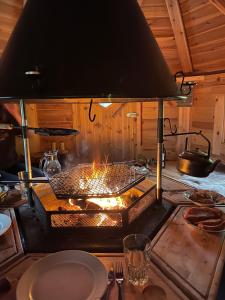 a kitchen with a stove with a grill in it at Vacation Home in Fjordgård with views of Segla and the Fjord in Fjordgård