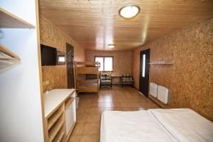 a room with a bed and a sink in a room at Chatový areál Zděřina in Police nad Metují