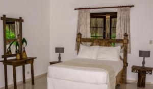 Postel nebo postele na pokoji v ubytování Hotel Rancho Don Cesar