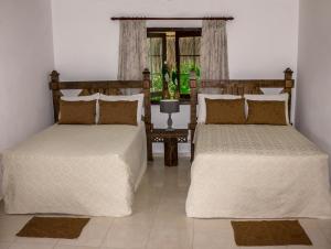 Postel nebo postele na pokoji v ubytování Hotel Rancho Don Cesar