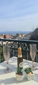 a bottle of champagne on a table with two glasses at I Love Mergellina in Naples