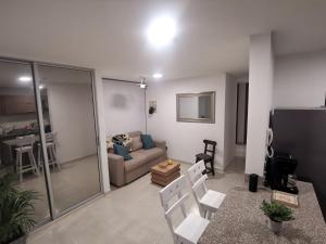 a living room with a couch and a table and chairs at Hermoso Apartamento Zona Norte Miramar # in Barranquilla