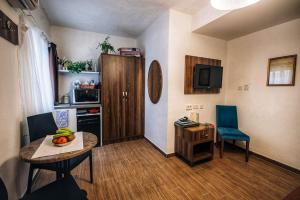 a living room with a table and chairs and a kitchen at Slimiza Suites in Sliema