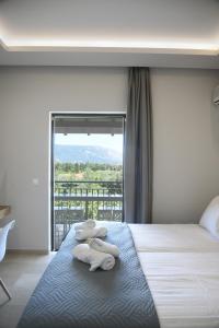 a hotel room with a bed with a large window at Spyridoula Resort in Corfu in Gouvia +42 photos