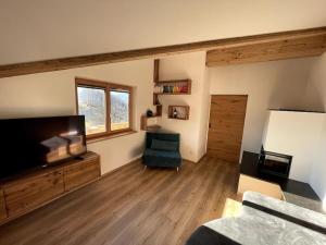 a living room with a large flat screen tv at Panorama Penthouse mit Sauna & großem Balkon in Gallzein