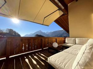 a bedroom with a bed and a view of mountains at Panorama Penthouse mit Sauna & großem Balkon in Gallzein