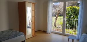 a bedroom with a sliding glass door to a balcony at Monteurswohnung Tim in Zweibrücken
