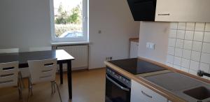a kitchen with a table and a stove top oven at Monteurswohnung Tim in Zweibrücken