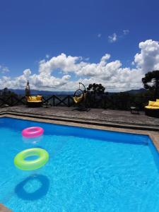 two frisbees in a swimming pool with a view at Pousada Village Pôr do Sol in Campos do Jordão