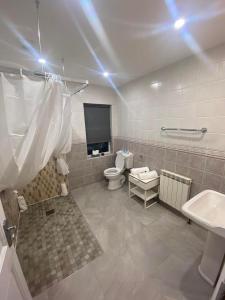 a bathroom with a toilet and a tv in it at SeaClusion Barna in Barna