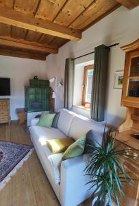 a living room with a white couch and a window at Ferienhaus Kranach 76 in Gamlitz