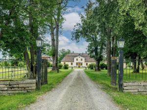a dirt road with a gate and a house at 5 person holiday home in FLEN-By Traum in Flen