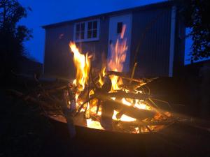 a fire pit in the yard at night at Miners Hut in St Austell