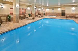 a pool in a hotel lobby with chairs and tables at Holiday Inn Express Hotel Twin Falls, an IHG Hotel in Twin Falls