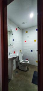 a bathroom with a toilet and a sink at Lala Loft Las Canteras in Las Palmas de Gran Canaria