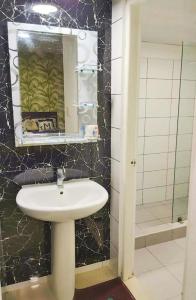 a bathroom with a sink and a mirror and a shower at Punta Cana Sol Caribe Beach Pool in Punta Cana