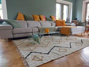 a living room with a couch and a rug at Au Clos Caleste in Wellin