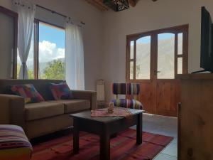 a living room with a couch and a table at Tierra Primitiva in Tilcara