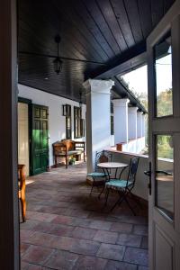 a porch of a house with a table and chairs at Szin-es Vendeghaz in Szentes